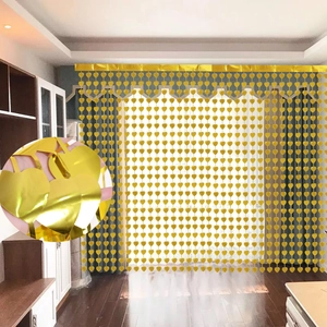 Detail showing hanging rose gold heart-shaped tinsel curtains for party background