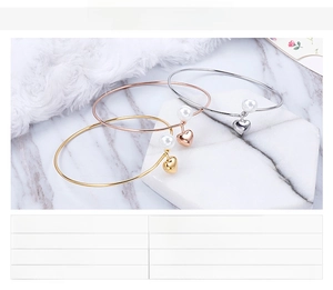 Three elegant heart and shell pearl bracelets in gold, silver, and rose gold finishes