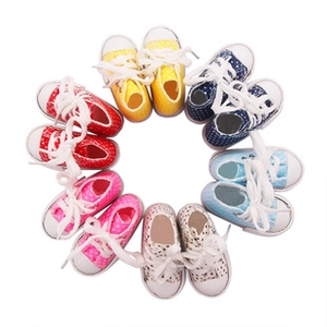 Overhead shot of 7.5cm mini canvas dolls shoes with white polka dots in six vibrant colors