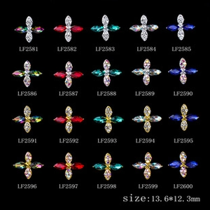 Macro detail of 13.6mm cross-shaped alloy nail charms with colorful rhinestones