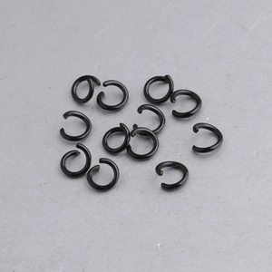 Macro view of several black stainless steel jump rings for jewelry making