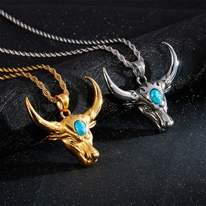 Vintage bull head pendant necklace in gold and silver with turquoise stone and twist chain