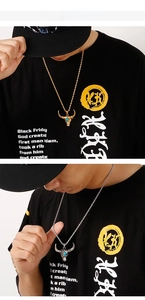Detailed view of vintage bull head necklaces in gold and silver finish with turquoise stone