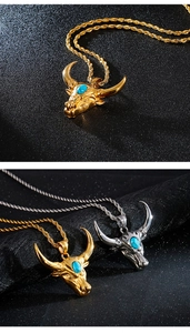 Detail of vintage bull head pendants with turquoise inlay in gold and silver finishes