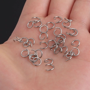 Macro shot of 0.8x6mm stainless steel open jump rings held in hand for DIY jewelry making