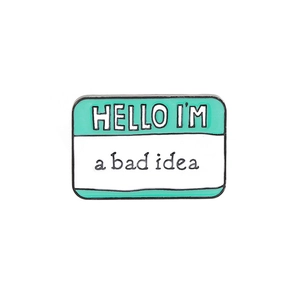 Detail of enamel lapel pin with Hello I'm a bad idea text in green and white colors