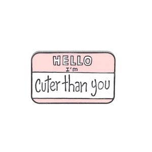 Cartoon Hello I'm Cuter Than You enamel pin badge with pink and white name tag design