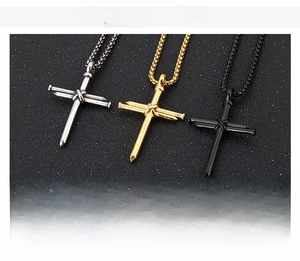 Detailed comparison of three stainless steel nail cross pendants in gold, silver, and black