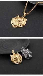 Detailed view of punk style wolf head pendants in gold and silver stainless steel