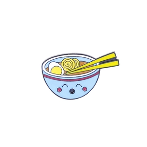 Macro detail of cartoon enamel noodle bowl brooch with smiling face and chopsticks