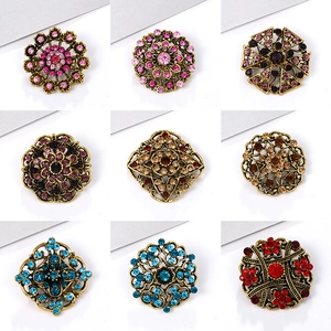 Set of nine vintage alloy brooches with colorful rhinestones in geometric flower designs