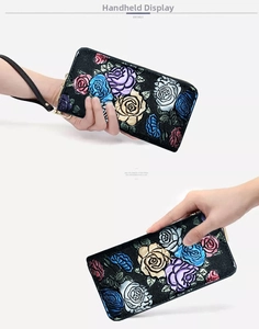 Detail view of colorful 3D rose embossing on black pebbled leather long wallet