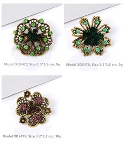 Detailed view of vintage hollow flower brooches with colorful rhinestones in bronze finish