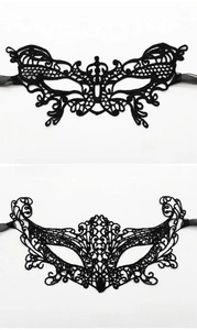 Detailed view of black lace masquerade masks in butterfly and fox styles with ribbons