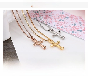Detailed view of 4g stainless steel cross necklaces in silver, gold and rose gold colors