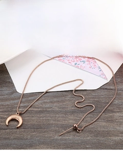 Detail of rose gold crescent moon pendant with box chain and adjustable bead clasp