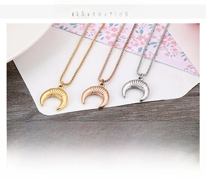 Detail of three-color stainless steel moon pendant necklace in gold, silver, and rose gold