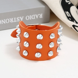 Bright orange punk faux leather wide bracelet featuring three rows of silver cone studs