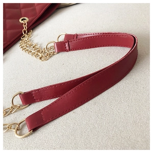 Detail of burgundy synthetic leather shoulder strap with gold metal chain link
