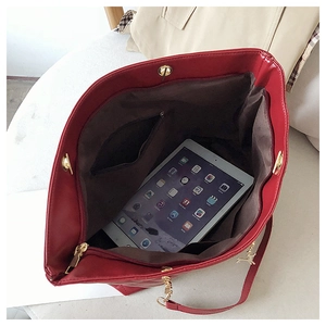 Detail view of red quilted tote bag interior with large capacity and golden hardware