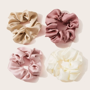 Set of four satin hair scrunchies in champagne, dusty rose, pink, and cream colors