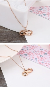 Detailed view of rose gold infinity symbol pendant necklace with delicate link chain