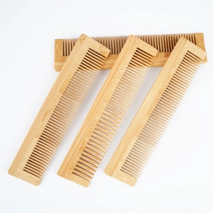 Detail view showing four natural bamboo combs with uniform teeth and clear wood grain texture