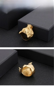 Detailed close-up of golden beast-head ring featuring intricate embossed patterns and textures