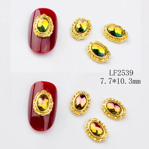 Macro detail of vintage oval alloy nail charms with colorful multifaceted rhinestones