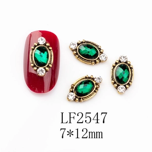 Detailed view of LF2547 emerald green oval nail art rhinestone with gold alloy setting