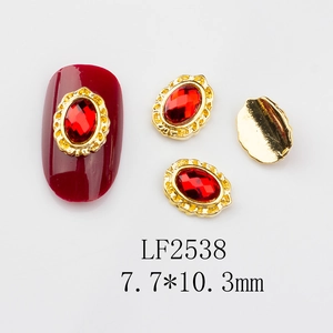 Close-up of vintage red oval gemstone nail art charm with gold frame and flat back