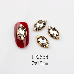 Detailed macro view of retro baroque nail art charm with 7x12mm oval crystal and gold base