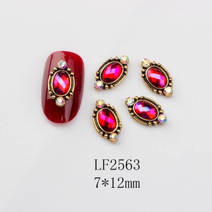 Macro detail of retro oval red gemstone nail charms with gold frame in 7x12mm size