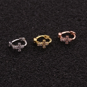 Detailed view of cross-shaped huggie earrings in silver, gold, and rose gold with zircon