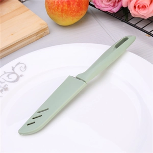 Green stainless steel fruit knife with protective sheath on a white patterned plate