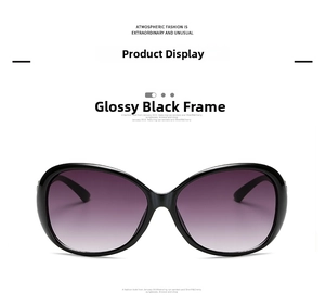 Detail view of oversized butterfly sunglasses featuring glossy black frames and purple gradient lenses