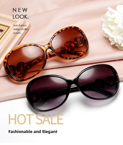 Close-up of stylish oversized sunglasses with tortoiseshell frames and chain link details
