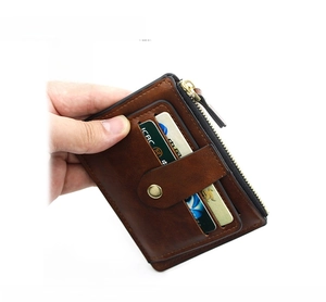 Brown vintage multi-card wallet detail with brass snap button and zipper pocket
