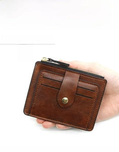 Detailed view of a brown vintage leather wallet with card slots and metal zipper pocket