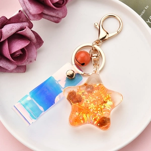 Detail of orange gradient starfish keychain with golden foil and iridescent laser strap