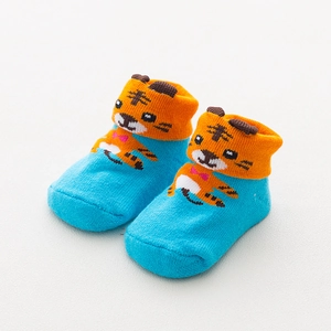 Detailed knit texture of baby socks featuring a blue tiger pattern and orange cuffs
