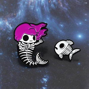 Gothic mermaid skull and fishbone enamel pin set with pink hair on starry background