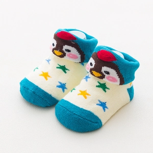 Close-up of baby socks featuring penguin character with colorful star patterns