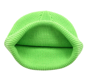 Detail view of the fluorescent green knit texture and internal stitching of the beanie