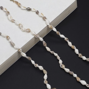 Macro detail of natural black and white seashell beaded chain for fashion eyewear