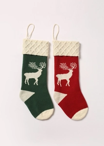 Close-up of knitted Christmas stockings with white reindeer patterns in red and green