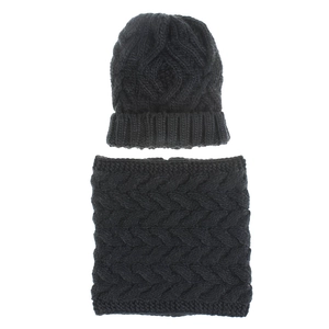 Detail of black cable knit beanie and neck warmer set with thick textured patterns