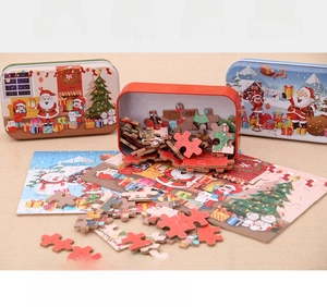 Detailed view of Christmas wooden puzzle pieces with colorful metal storage tin for kids