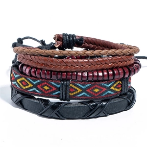 Detail of five-piece ethnic woven bracelet set with wood beads and leather cords