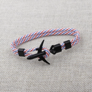 Detail of red, blue and white braided paracord bracelet with black airplane clasp